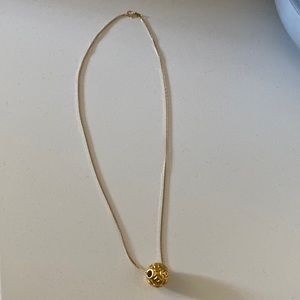 Elegant Gold Necklace with Intricate Pendant